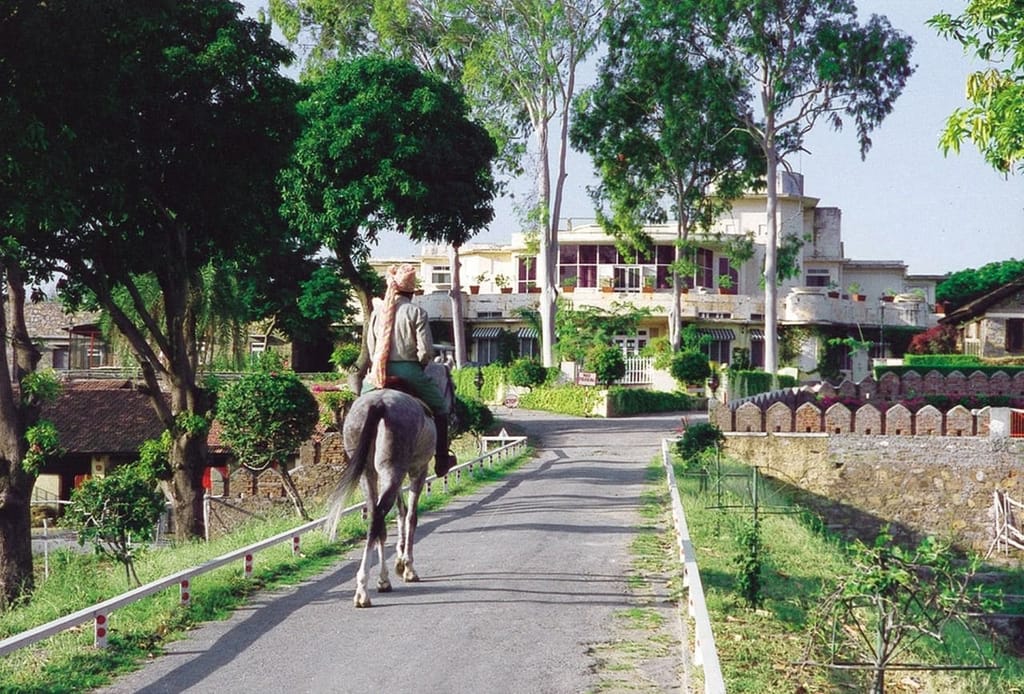 Rider on the drive past the lodge