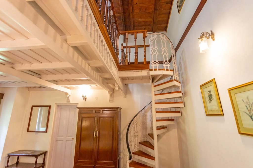 White spiral staircase to the Cuckoo attic loft