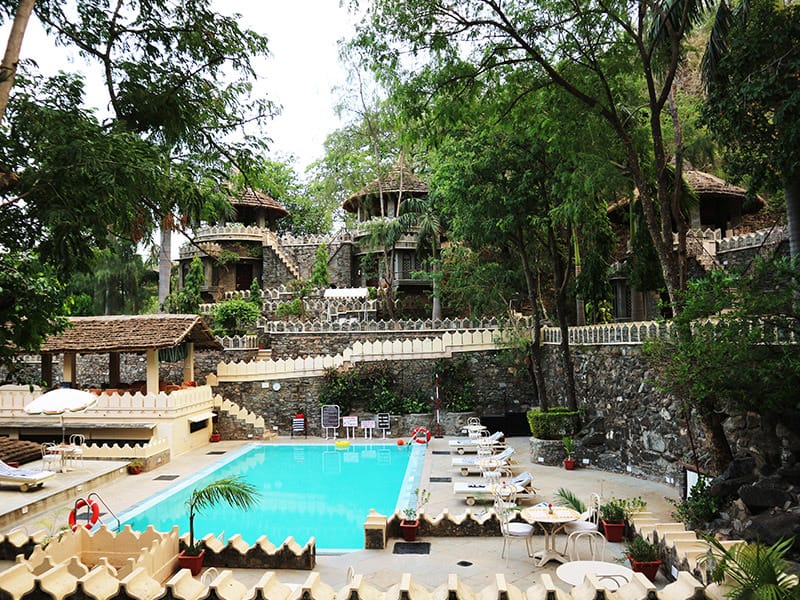 Pool terraced into the hillside below stone cottages