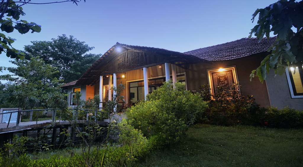 The lodge at dusk, its windows lit