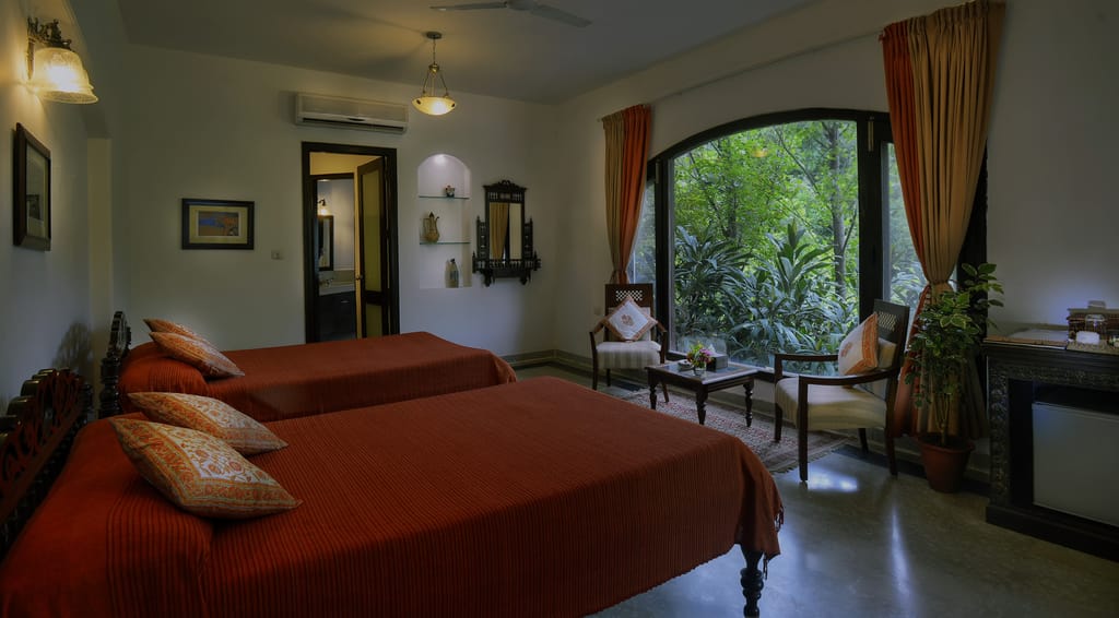 A suite bedroom with the forest through the window