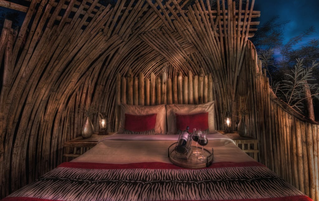 A bamboo thatched bedroom with red accents