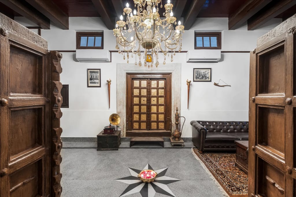Entrance hall with chandelier and brass-clad door