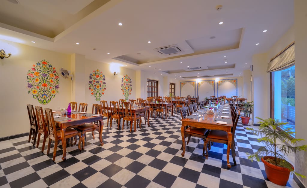 Jharokha restaurant with chequerboard floor and folk wall art