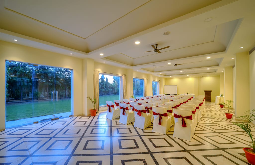 Banquet hall set theatre-style with lawn views through full-height glazing