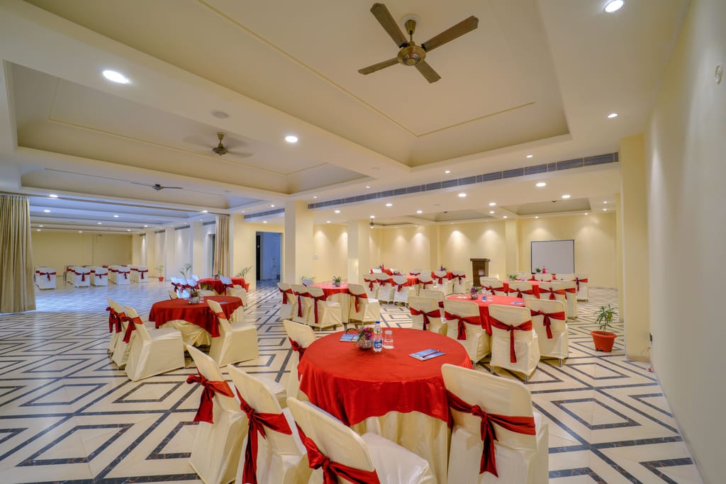 Event hall with round tables dressed in red