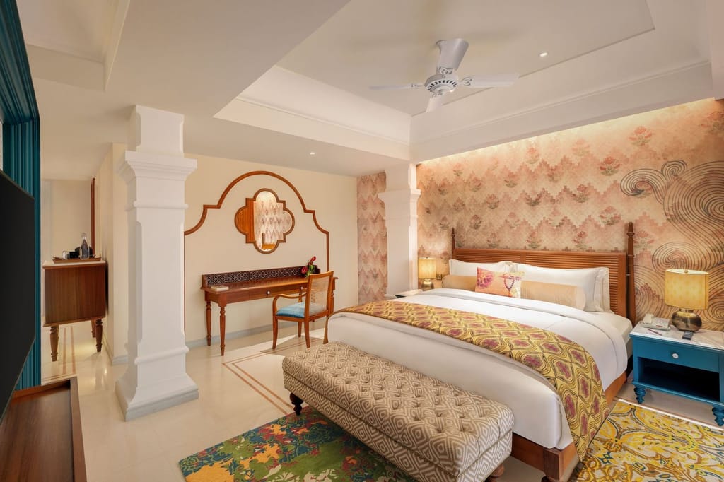 SeleQtions Suite bedroom with four-poster bed, floral wallpaper and dressing table at Pilibhit House, Haridwar