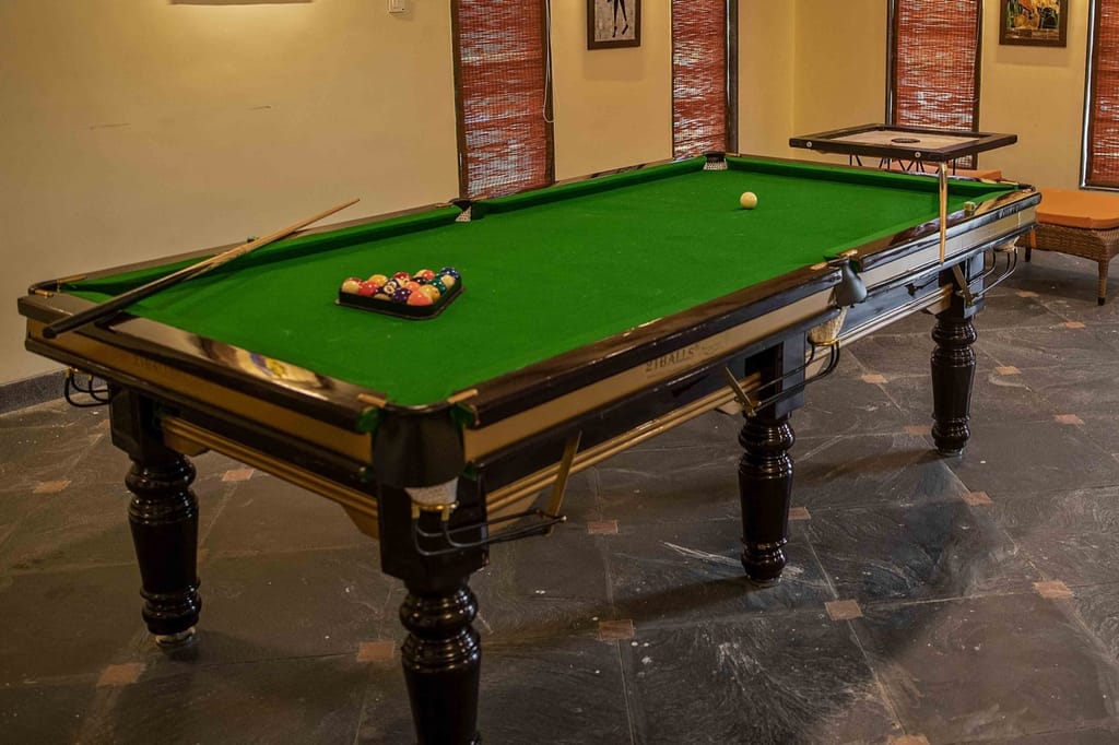 Games room with pool table and carrom board at WelcomHeritage Tadoba Vanya Villas, Tadoba