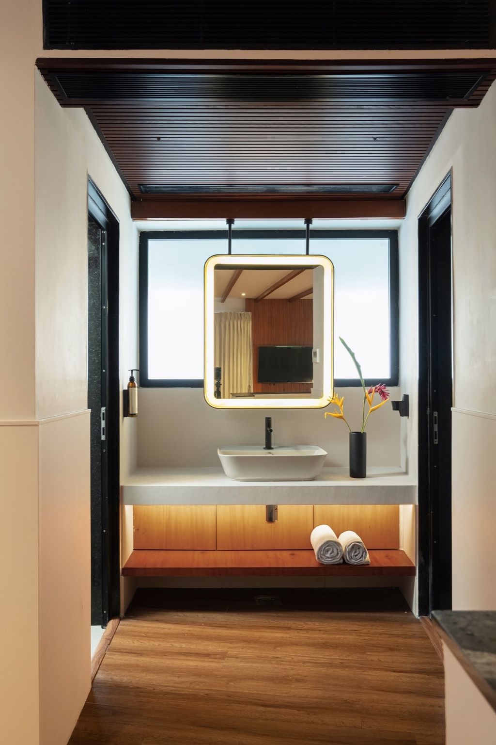 Pondview Suite bathroom with lit mirror, basin and rolled towels, Coco Lagoon by Great Mount, Pollachi