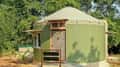 A yurt at Tathastu Kanha, green canvas on a round frame