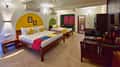 A family villa bedroom at Tathastu Kanha, two beds and a bright headboard