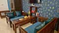The living room of a family villa at Tathastu Kanha, teal sofas