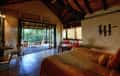 A bungalow at Kanha Earth Lodge opening onto its veranda