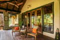The veranda of a bungalow at Kanha Earth Lodge