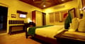 Tea Bungalow, Fort Kochi: Heritage Premium Room with wood-panelled ceiling, green bed runner, desk and wardrobe