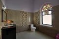 A bathroom with a stained-glass window