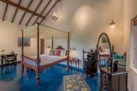 Aqua room with four-poster bed and blue floor