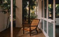 Planter's chair on a verandah beside the garden