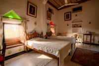 Twin beds under a white pitched ceiling