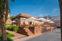 Baradari terrace with parasols and sandstone walls