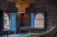 Heritage suite bed between blue shutters