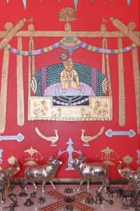 Krishna painting on red wall with silver deer