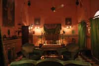 Bedroom with green velvet armchairs