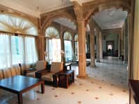 Carved stone pillars along a shaded verandah