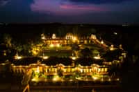 The property lit at night from above, showing the courtyard layout
