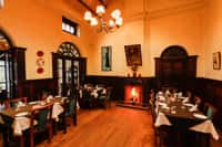 Panelled dining room with lit fireplace