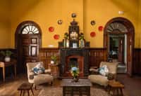 Lounge with carved wooden fireplace and sofas