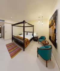 Regal Room with four-poster bed and armchairs