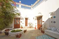 Courtyard with blue trim and planted bed