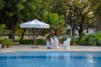 Swimming pool with umbrella and loungers