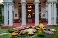 Assamese meal laid on banana leaf outside the portico