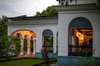 Arched verandah with lit interiors at twilight