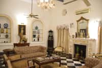 Drawing room with marble fireplace and chequered floor