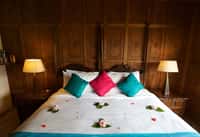 Bed against a carved walnut panelled wall