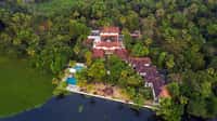 Aerial view of the property and pool on the lakeshore