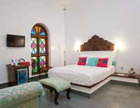 Bedroom with arched stained glass window