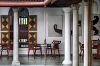 Colonnaded verandah restaurant with stained glass shutters