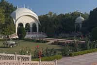 White garden pavilion and rose beds
