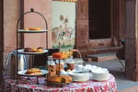 Tiered afternoon tea stand against painted wall