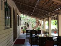 Covered verandah with dark wood seating and lanterns