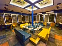 The bar at Tathastu Pench with its yellow sofas