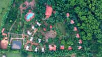 Tathastu Kanha from the air, the pool and roofs among the trees