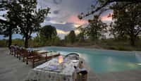 The pool at Pench Tree Lodge at sunset