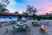 The farm dinner setting at Pench Tree Lodge, blue walls and lanterns