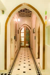 Arched corridor with black and white marble floor