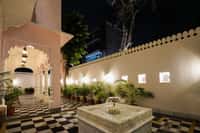 Marble fountain and chequered courtyard at Dev Mahal, Jaipur, at night